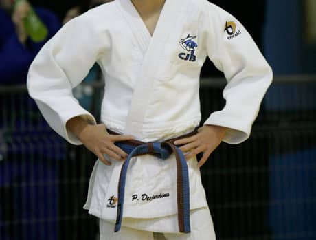 Judoka avec les mains sur les hanches.